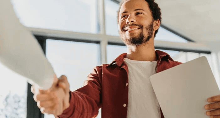 A student shaking hands with a teacher