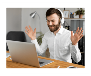 A young corporate man talking to his online language teacher through his laptop